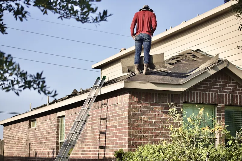 Professional roofer working on a residential roof in Monkton